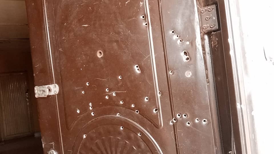 A door riddled with bullets