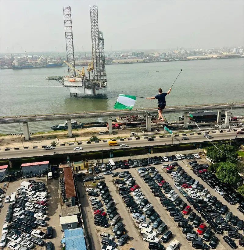 Man captured walking on rope across bridge, train tracks in Lagos [Video]