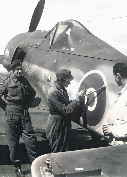 Captured German FW-190 getting an RAF roundel painted on the fuselage.[Photo]