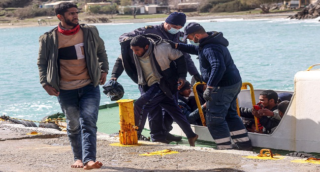Migrants disembark from a boat at the port of Kali Limenes, in Heraklion, southern Crete,