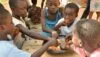 Children eating on the floor (Credit: Momo Africa)