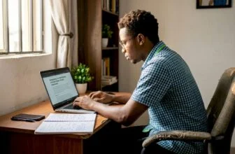 Young Nigerian professional working on laptop at desk