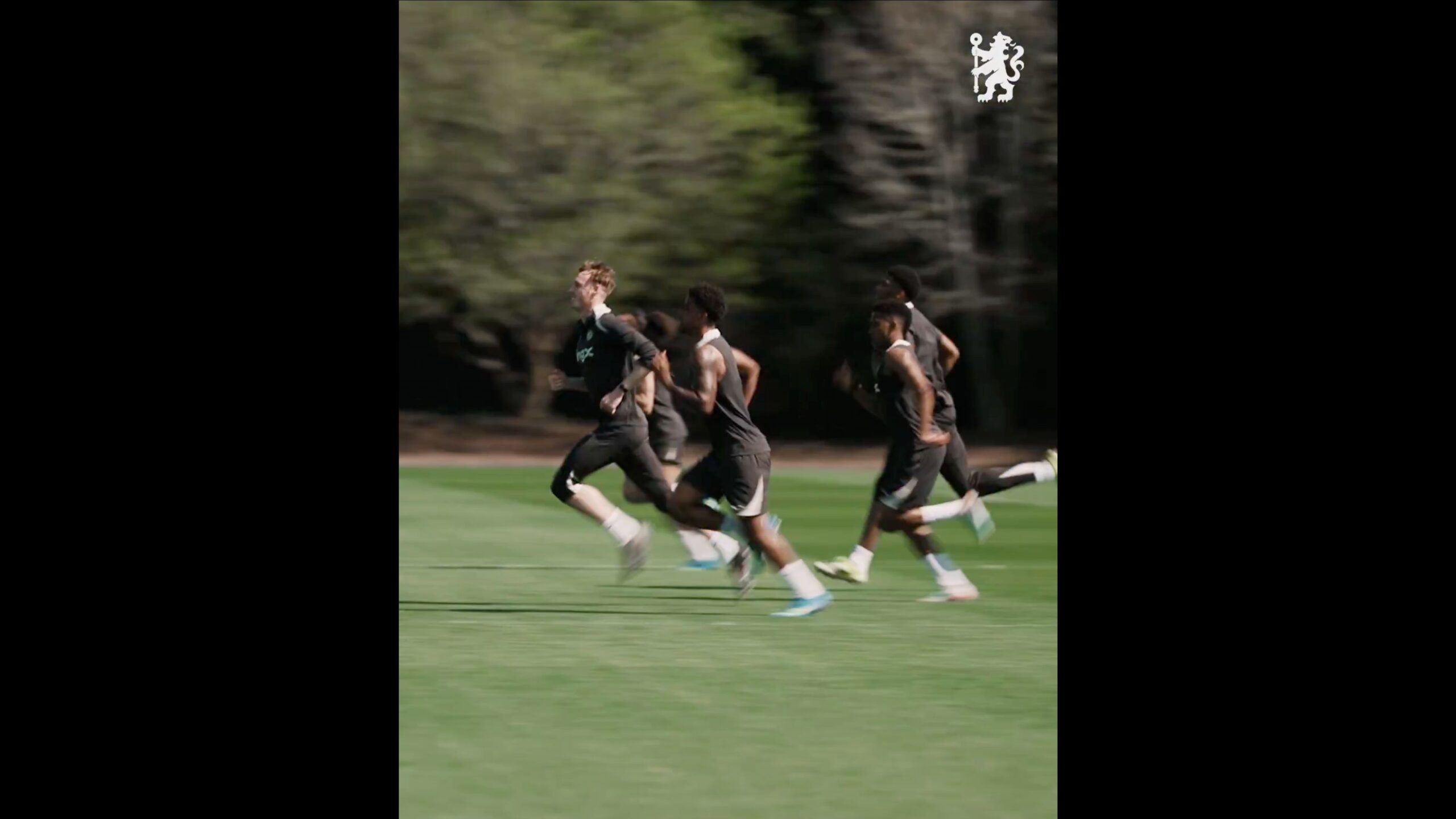 Chelsea players sprint in training.