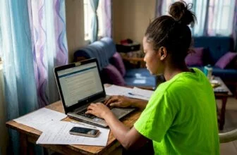 Nigerian woman drafting news tip in home
