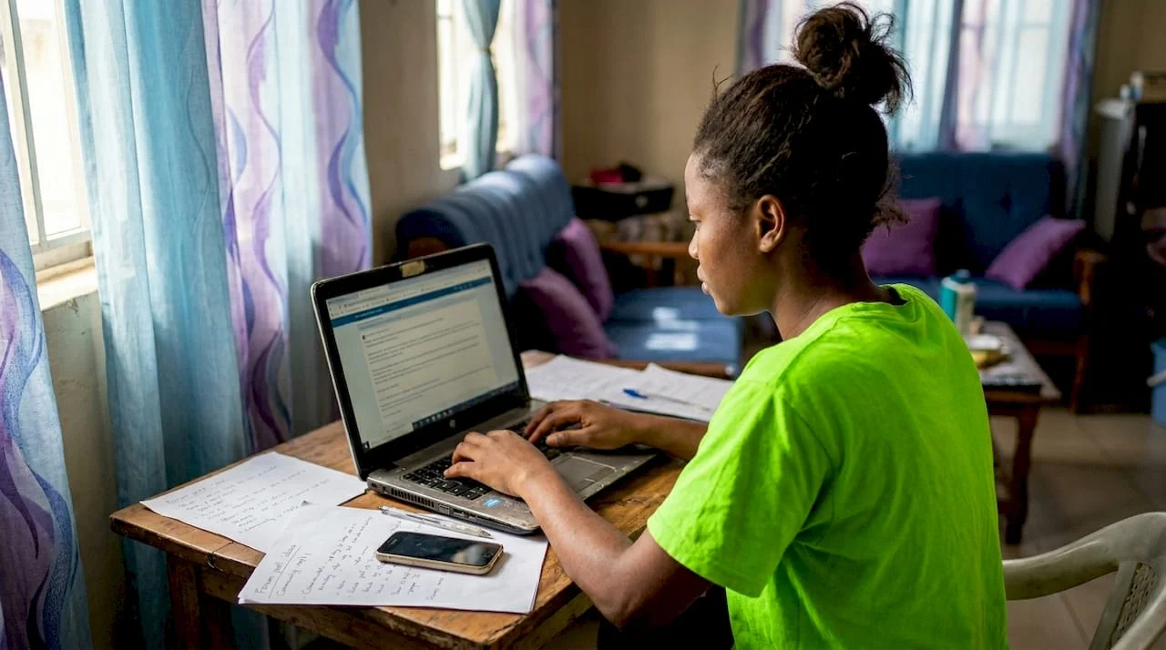 Nigerian woman drafting news tip in home