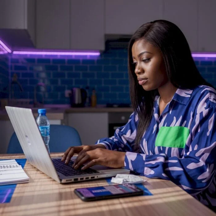 Woman submitting news article from Lagos apartment