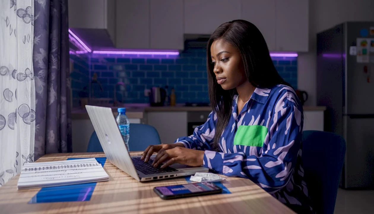 Woman submitting news article from Lagos apartment