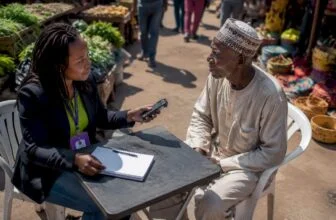 Community journalist interviewing elderly man outdoors