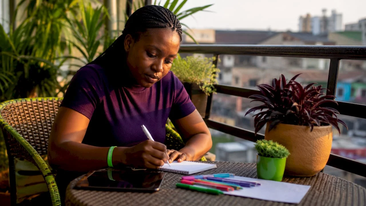 The Role of Citizen Feedback in Nigerian Governance 1 Nigerian woman writing citizen feedback at home desk