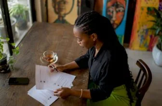 Nigerian woman moderating printed comments at desk