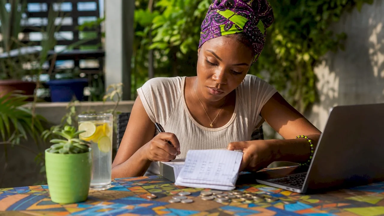 Young Nigerian woman reviewing budget at home