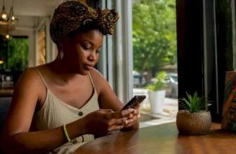 Nigerian woman completing online registration on phone