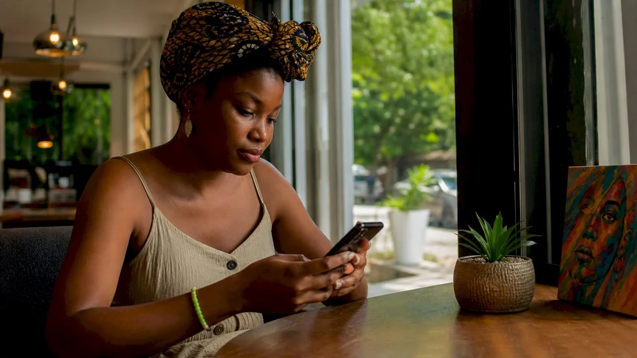 Step by Step Online Registration: A Nigerian User's Guide 1 Nigerian woman completing online registration on phone
