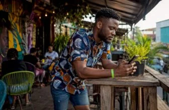 Man checking entertainment updates on phone at market