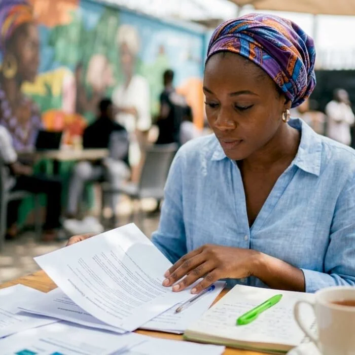 Female journalist reviewing transparency guidelines at desk