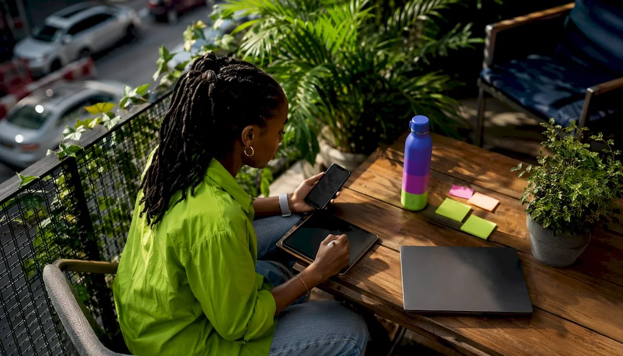 What Is Viral Marketing? Your 2026 Strategy Guide 1 Marketer using tablet and phone at desk