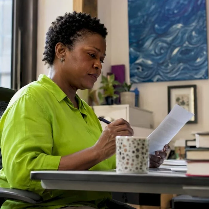 Woman reviewing misinformation article at desk