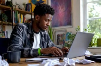 Young man typing viral post at home desk