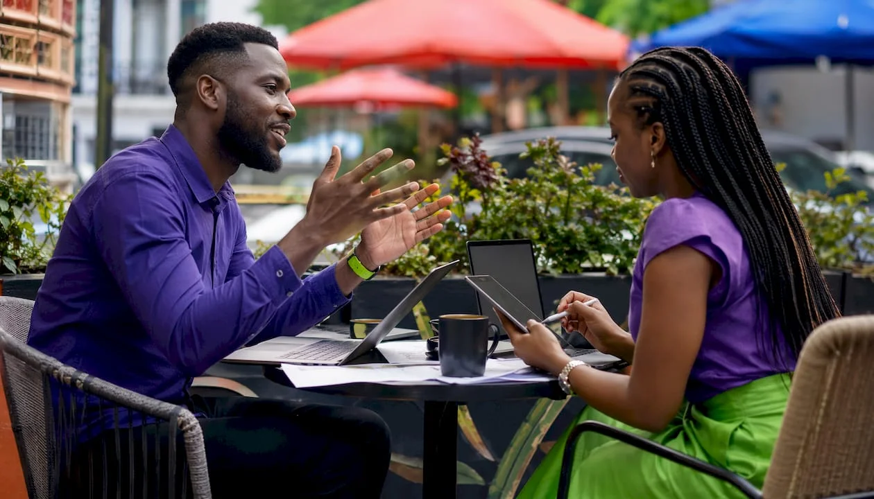 Two writers collaborating on satirical news scripts