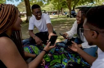 Hands exchanging smartphones outdoors