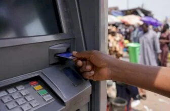Hand inserting debit card at Nigerian ATM