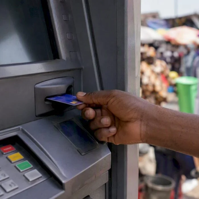 Hand inserting debit card at Nigerian ATM