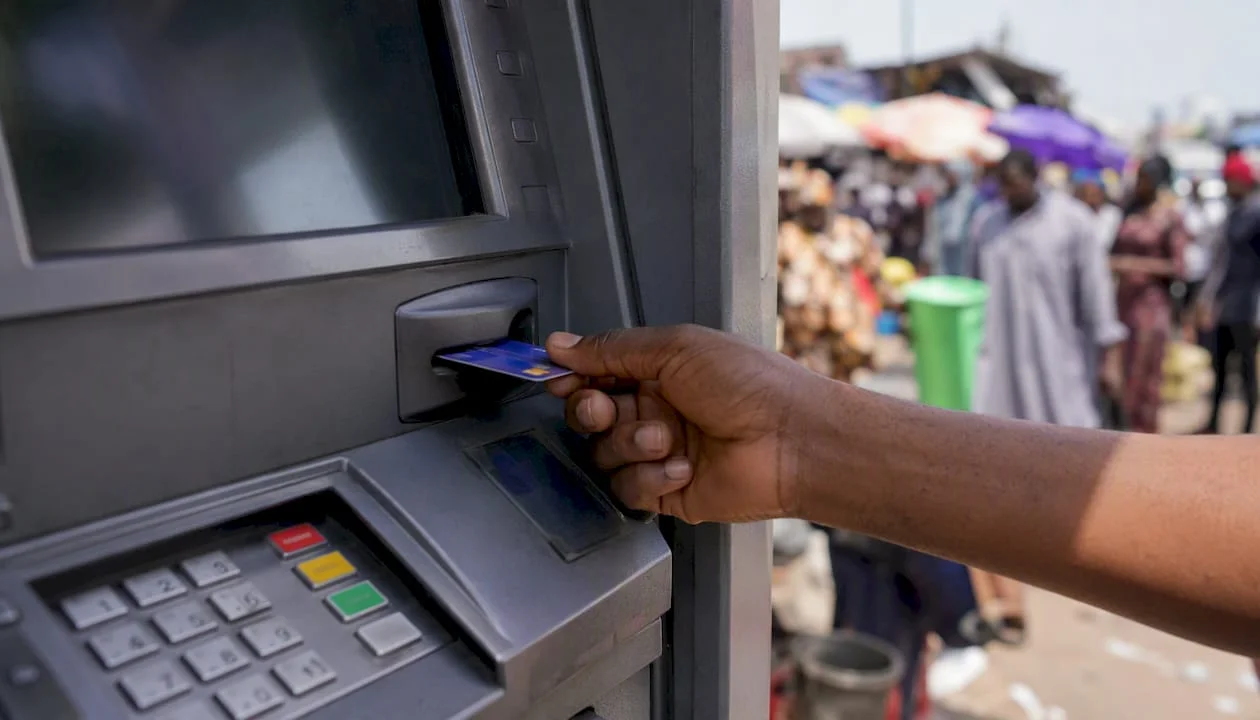 Nigeria's Cashless Policy: What You Need to Know 1 Hand inserting debit card at Nigerian ATM