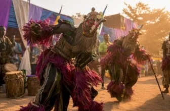 Masquerade performers in colorful Nigerian festival costumes