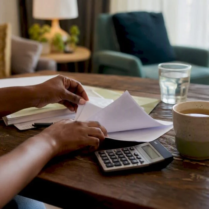 Hands managing household budget papers