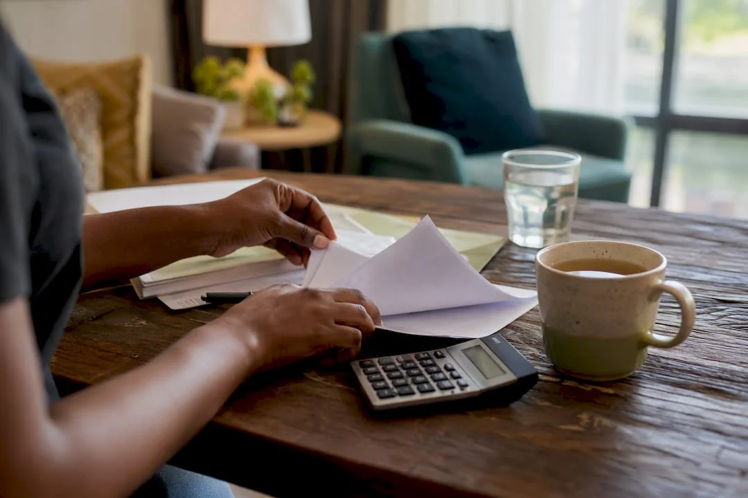 Nigeria's Cost of Living in 2026: What You'll Actually Spend 1 Hands managing household budget papers