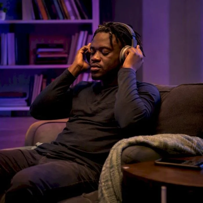 Person adjusting headphones ready to listen to podcast