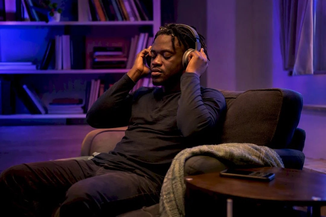 Person adjusting headphones ready to listen to podcast