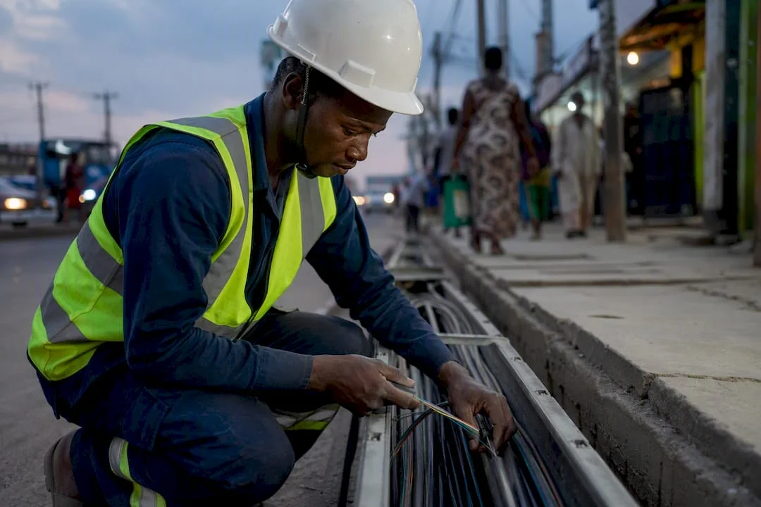 Hands installing fiber optic cables for telecom backhaul
