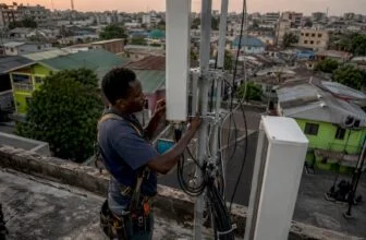 Technician installing 4G antenna in Nigerian city
