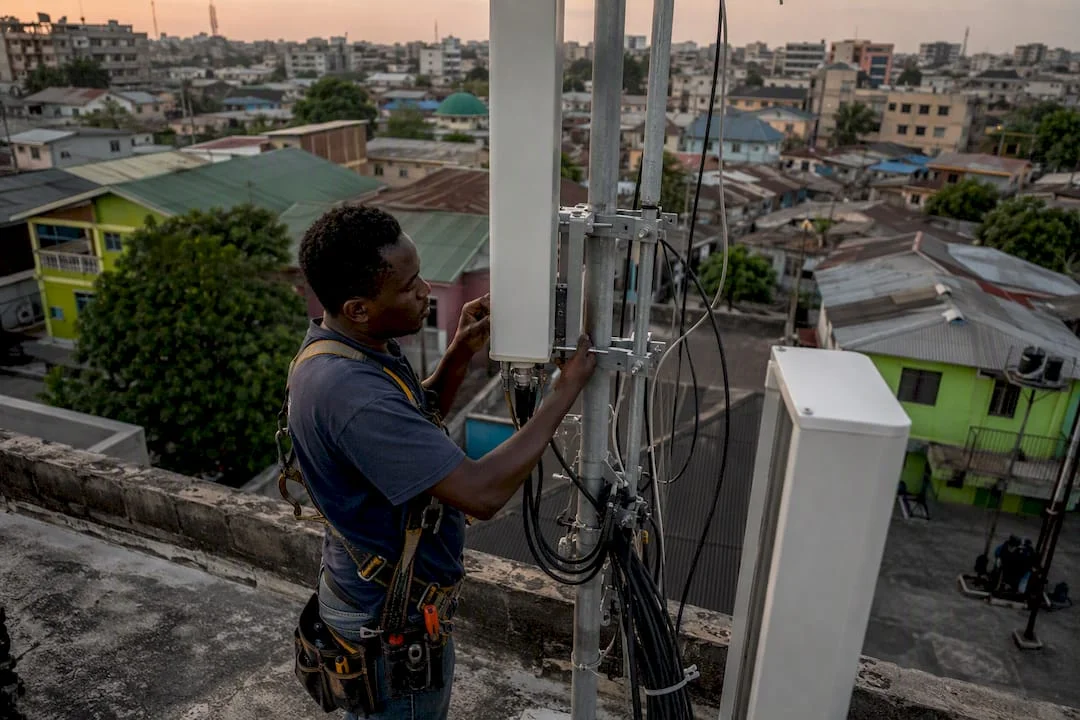 Technician installing 4G antenna in Nigerian city