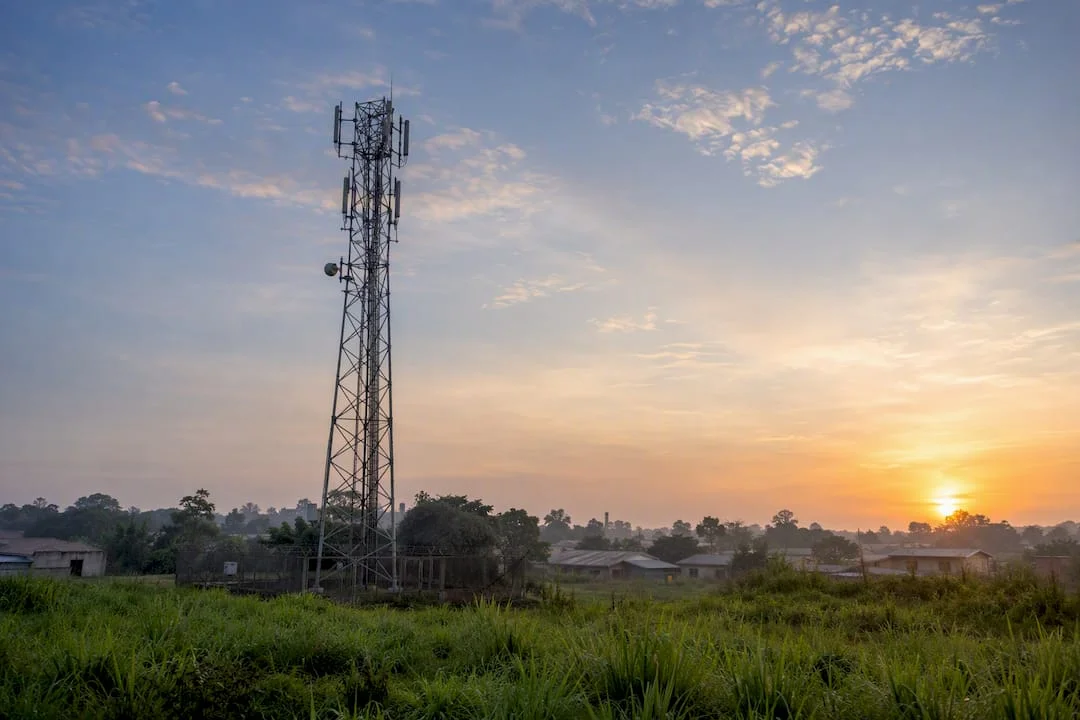 Rural Nigerian village telecom tower at dawn