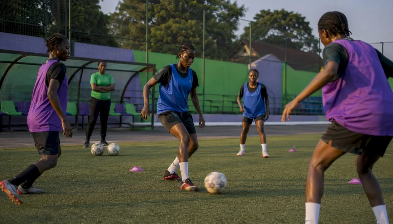 Nigerian girls training on football pitch
