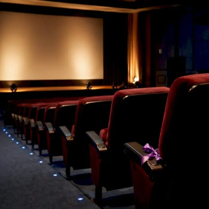Empty Nigerian cinema auditorium under tribute lighting