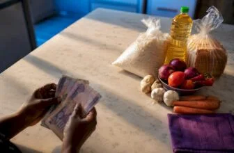 Naira notes beside everyday household staples