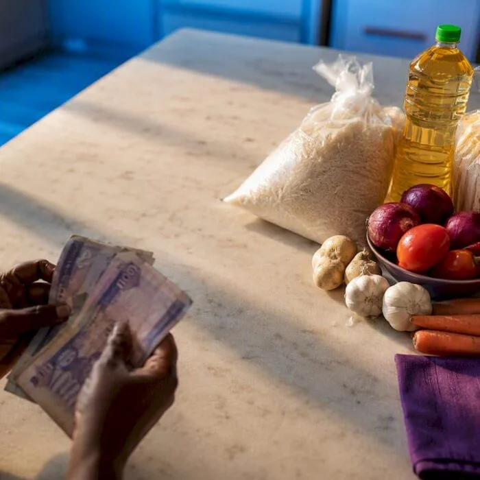 Naira notes beside everyday household staples