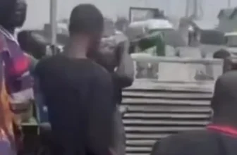 Bystanders drink beer from crashed truck in Lagos