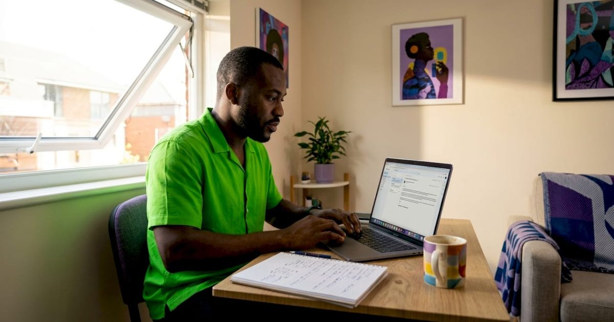 How to Avoid Internet Scams in Nigeria: Types, Red Flags and What to Do (2026) 1 Nigerian man reviewing email cautiously at home