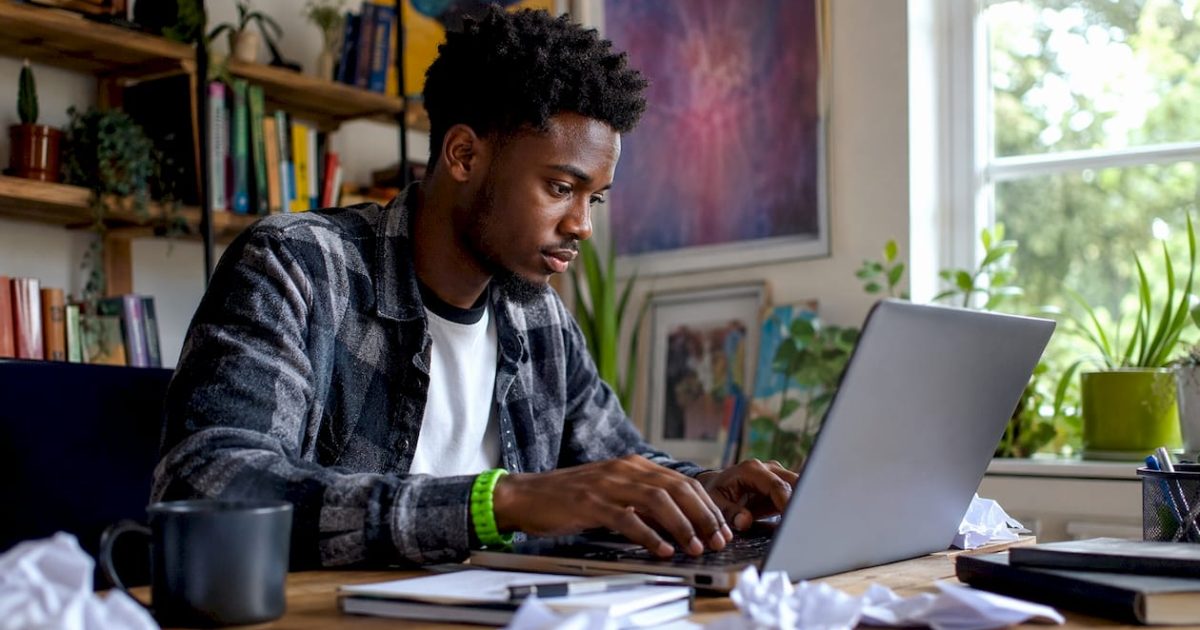 Why Do Posts Go Viral: A Forum Poster's Guide 1 Young man typing viral post at home desk