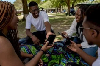 Hands exchanging smartphones outdoors