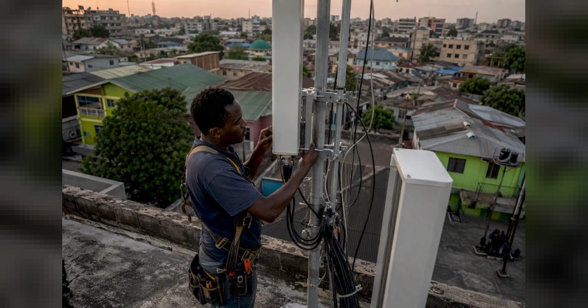 Technician installing 4G antenna in Nigerian city