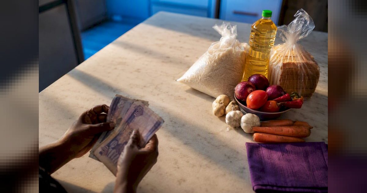 Naira notes beside everyday household staples